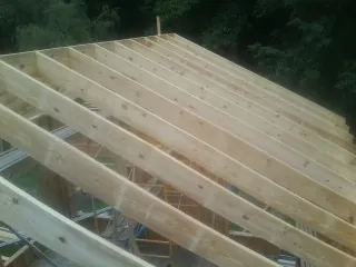 New roof rafters set over an addition before sheathing in Salisbury Mills