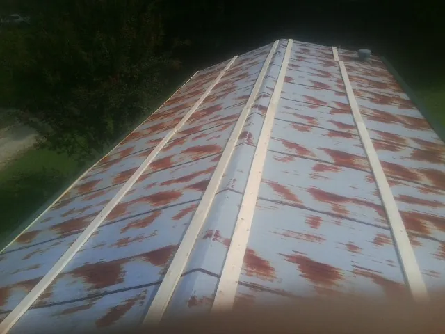 Rusted metal roof panels with new wood purlins before replacement — Storm Damage Roof Repair in Salisbury Mills by Roofing Brothers