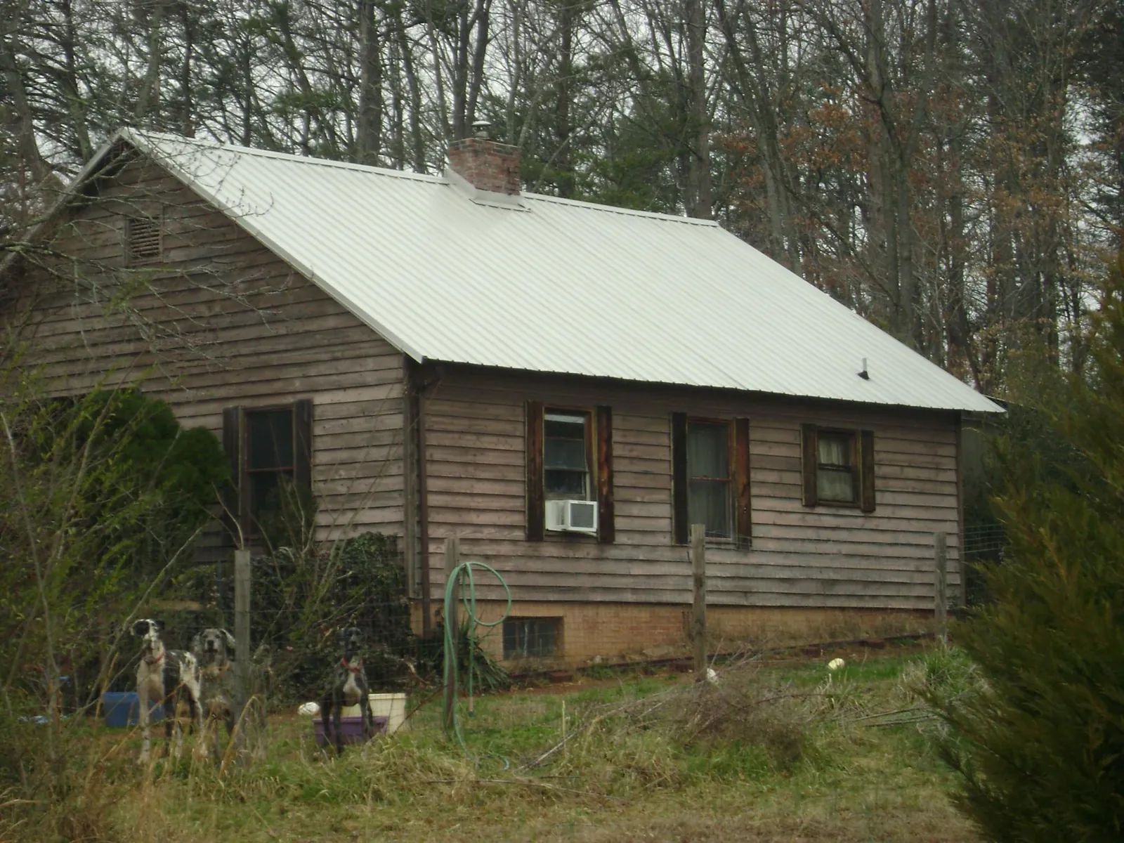 White metal roof on an old wood sided farmhouse, from a Metal Roof Installation job in Salisbury Mills